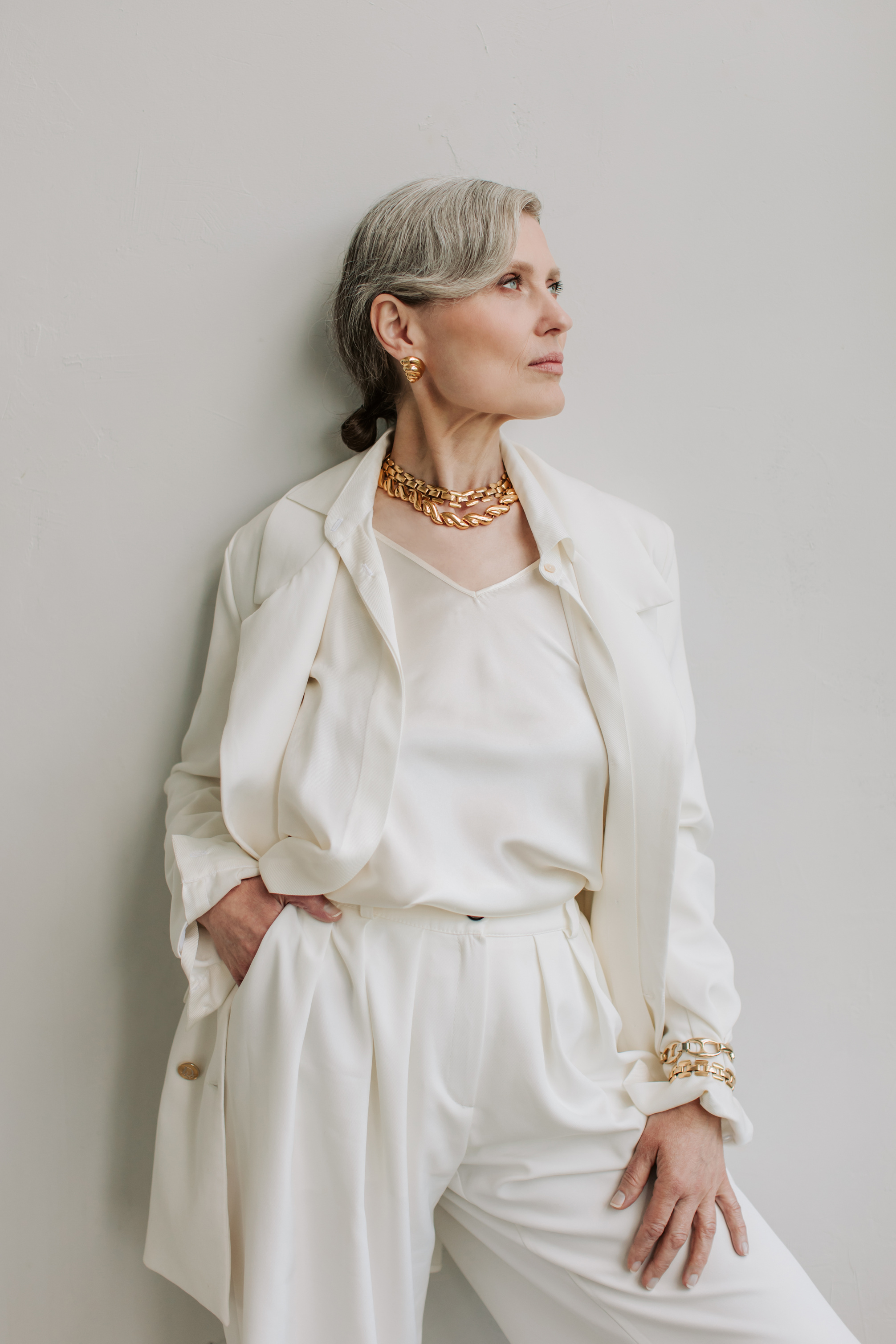 Portrait of an Elegant Senior Woman in Gold Jewelries